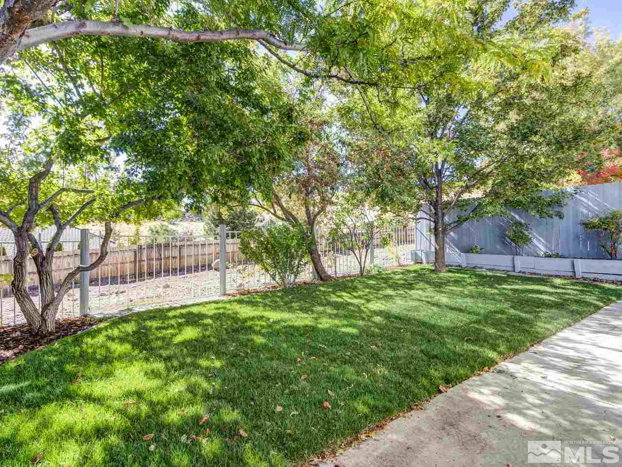 2678 Alpine Creek Road Reno, NV 89519 - Photo 19 of 25 a backyard of a house with lots of green space and fountain