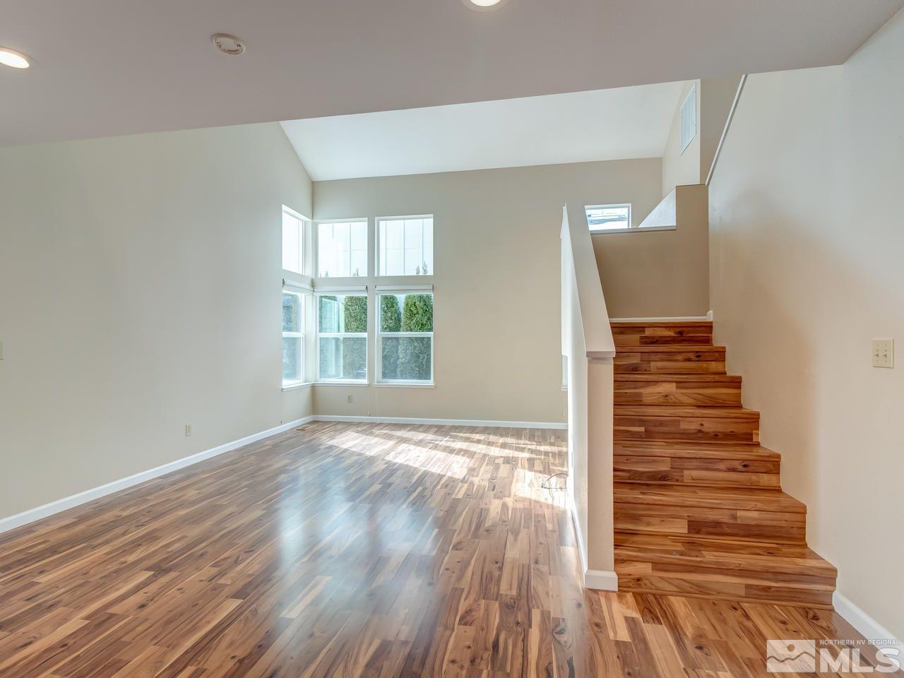2678 Alpine Creek Road Reno, NV 89519 - Photo 4 of 25 a view of an empty room with wooden floor and windows