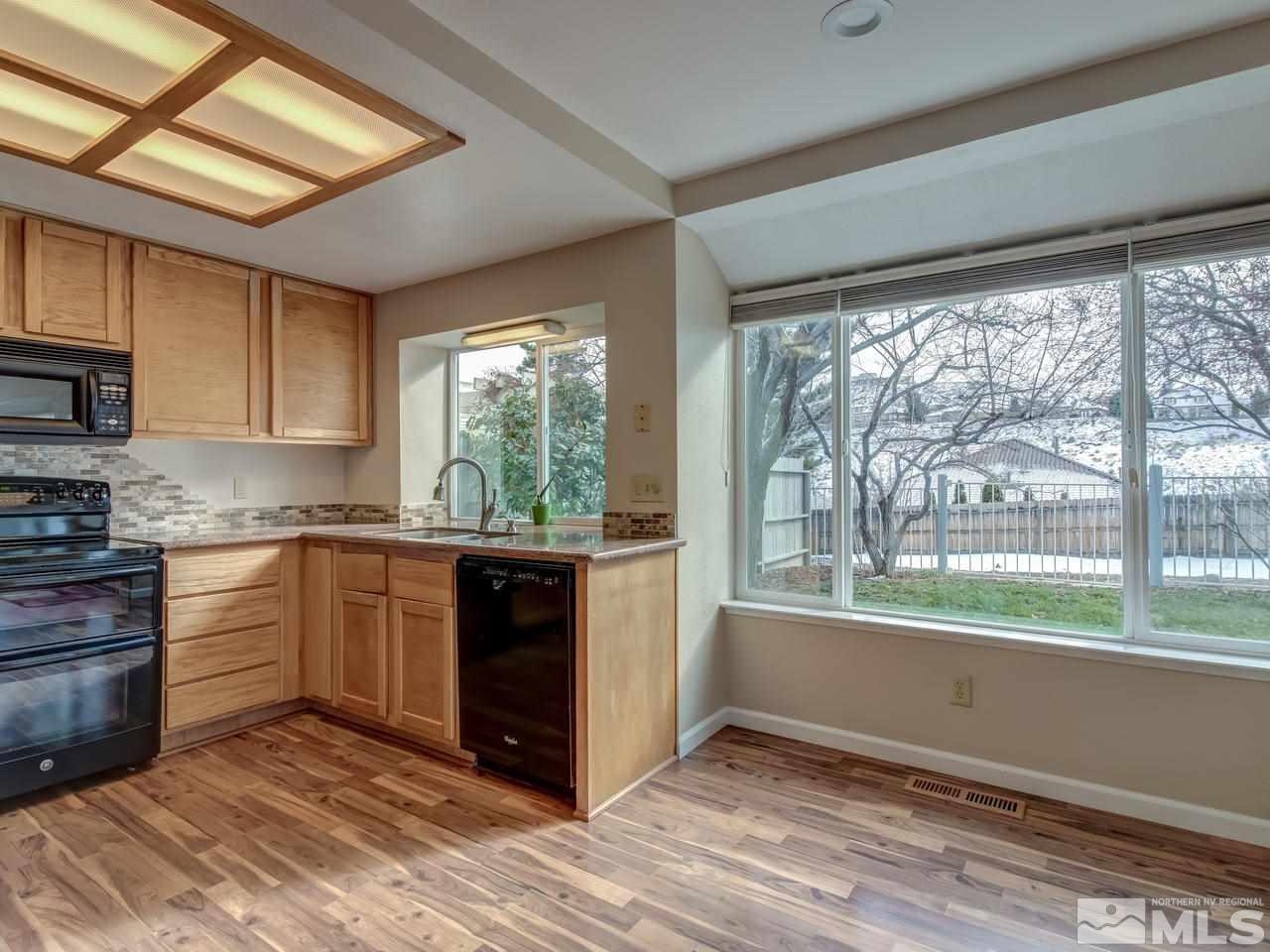2678 Alpine Creek Road Reno, NV 89519 - Photo 8 of 25 a kitchen with stainless steel appliances granite countertop a stove a sink and a microwave
