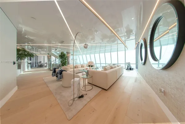 a dining room with furniture and a window