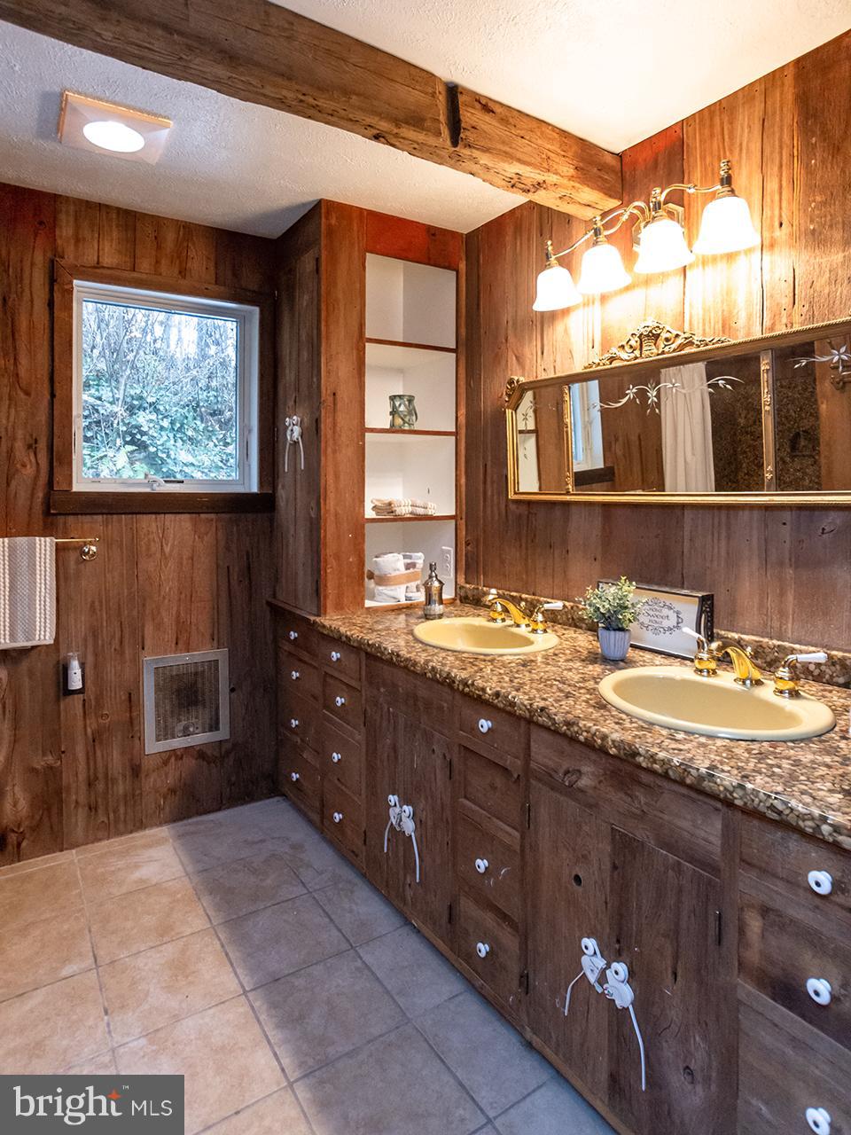 2504 West Ruhl Road Freeland, MD 21053 - Photo 18 of 43 a bathroom with a granite countertop sink a mirror and a vanity