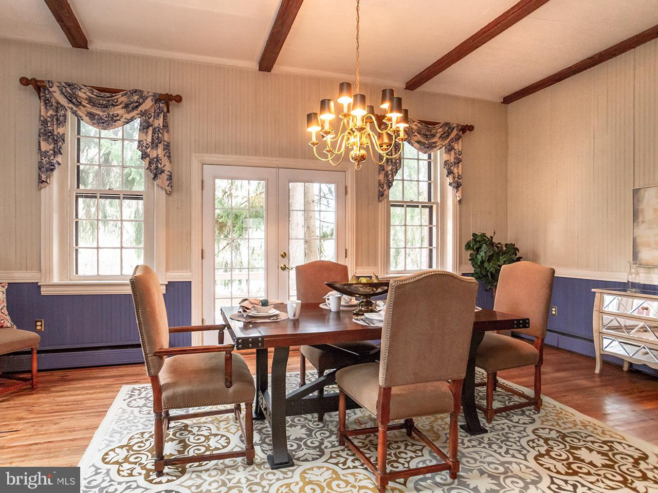 2504 West Ruhl Road Freeland, MD 21053 - Photo 3 of 43 a view of a dining room with furniture a chandelier and wooden floor