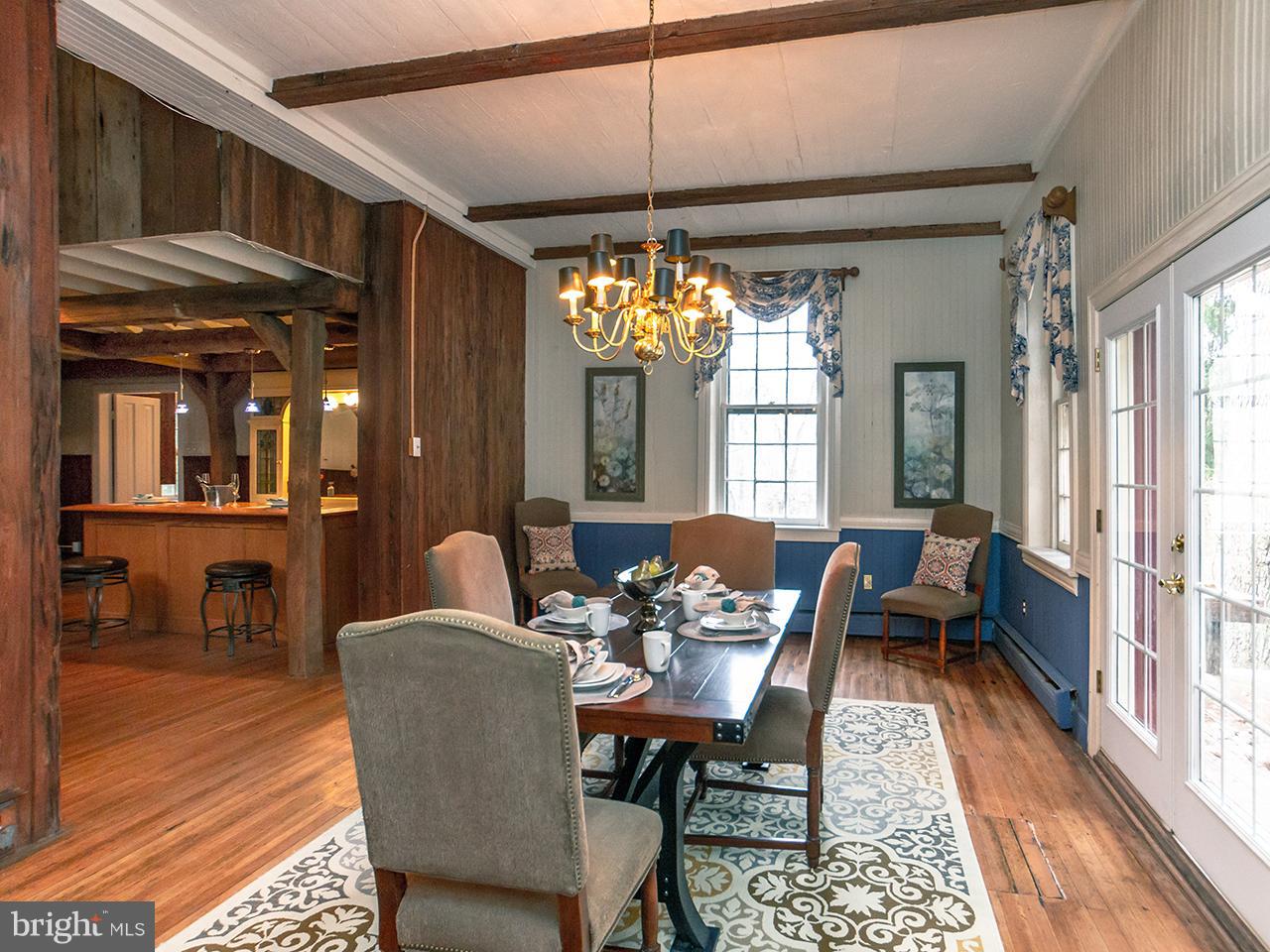 2504 West Ruhl Road Freeland, MD 21053 - Photo 25 of 43 a dining room with furniture a chandelier and wooden floor