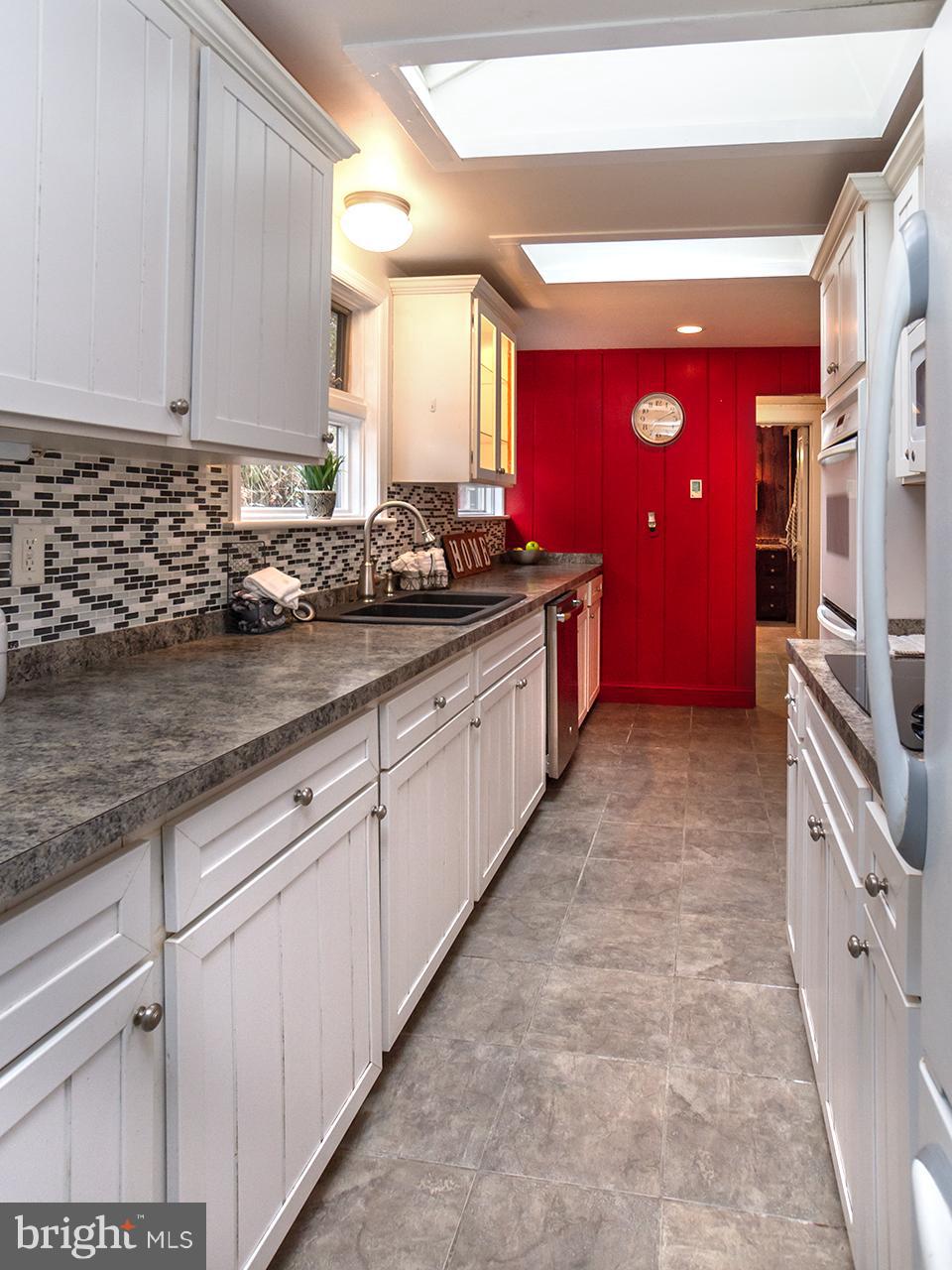 2504 West Ruhl Road Freeland, MD 21053 - Photo 40 of 43 a kitchen with stainless steel appliances granite countertop a stove a sink and a refrigerator