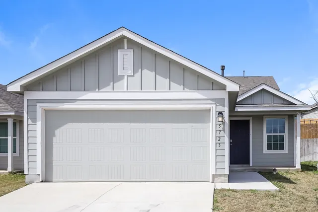 a front view of a house with garage