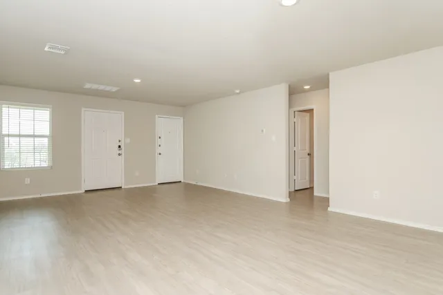 an empty room with windows and closet