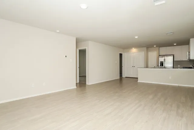 a view of a kitchen with kitchen island and wooden floor