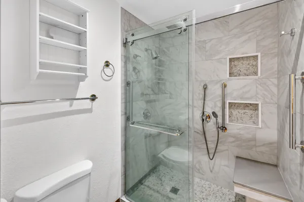 a bathroom with a granite countertop double vanity sink and a mirror