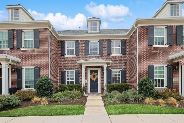 front view of brick house with a yard