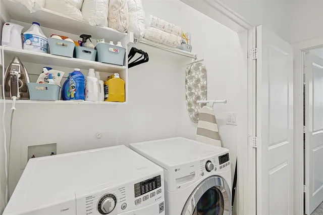 a view of backyard with table and chairs and potted plants