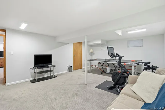 a view of a livingroom with furniture and a flat screen tv
