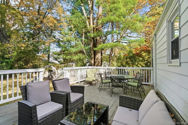 a view of a patio with couches chairs and wooden floor