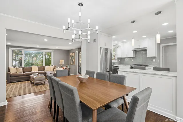 a large kitchen with kitchen island a dining table and chairs