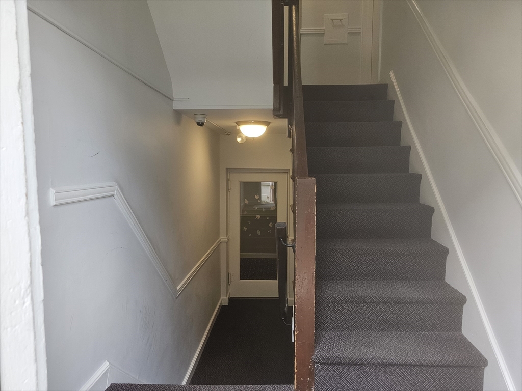 60 Elm Street, Unit 2A Worcester, MA 01609 - Photo 12 of 13 a view of staircase with white walls and door