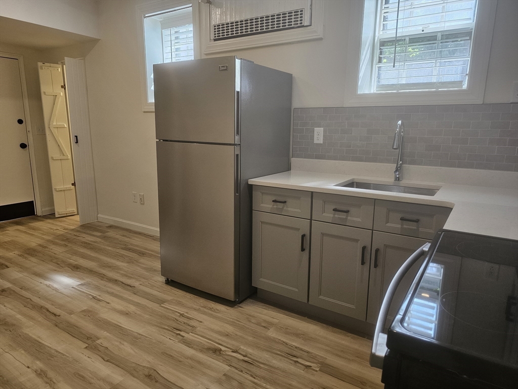 60 Elm Street, Unit 2A Worcester, MA 01609 - Photo 5 of 13 a white refrigerator freezer sitting inside of a kitchen