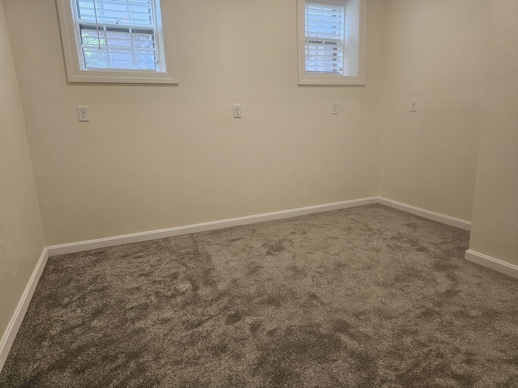 60 Elm Street, Unit 2A Worcester, MA 01609 - Photo 8 of 13 an empty room with a workbench