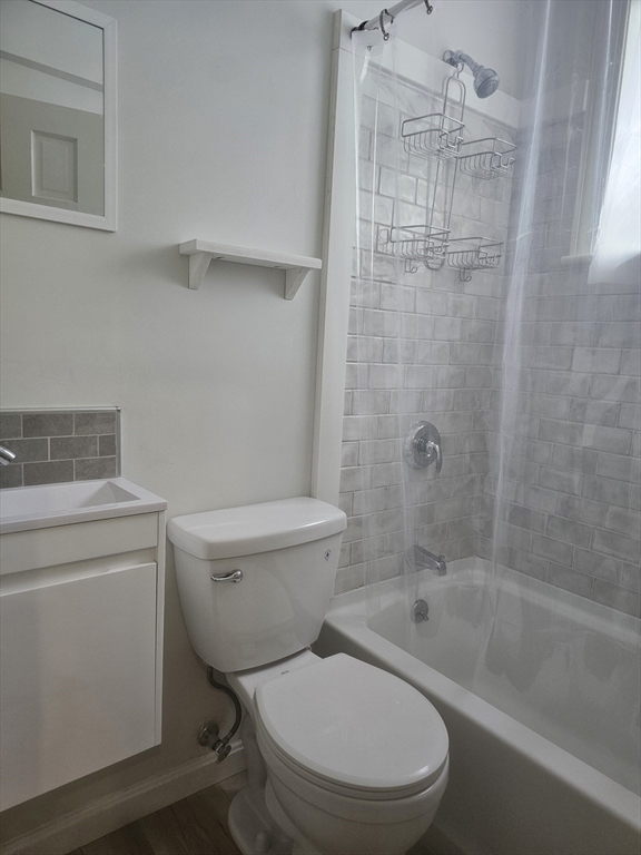 60 Elm Street, Unit 2A Worcester, MA 01609 - Photo 9 of 13 a bathroom with a granite countertop toilet a sink and shower