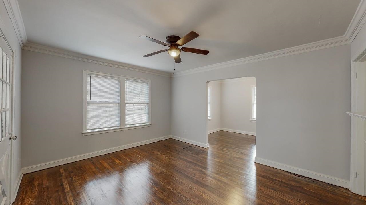 3393 Carrington Road Memphis, TN 38111 - Photo 2 of 11 Unfurnished room featuring arched walkways, ornamental molding, plenty of natural light, dark wood-type flooring, and ceiling fan