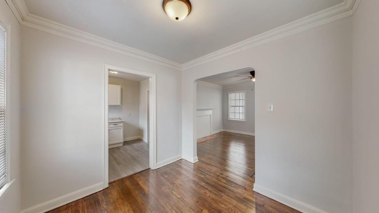 3393 Carrington Road Memphis, TN 38111 - Photo 4 of 11 Unfurnished room featuring ornamental molding, dark wood-style flooring, and a ceiling fan