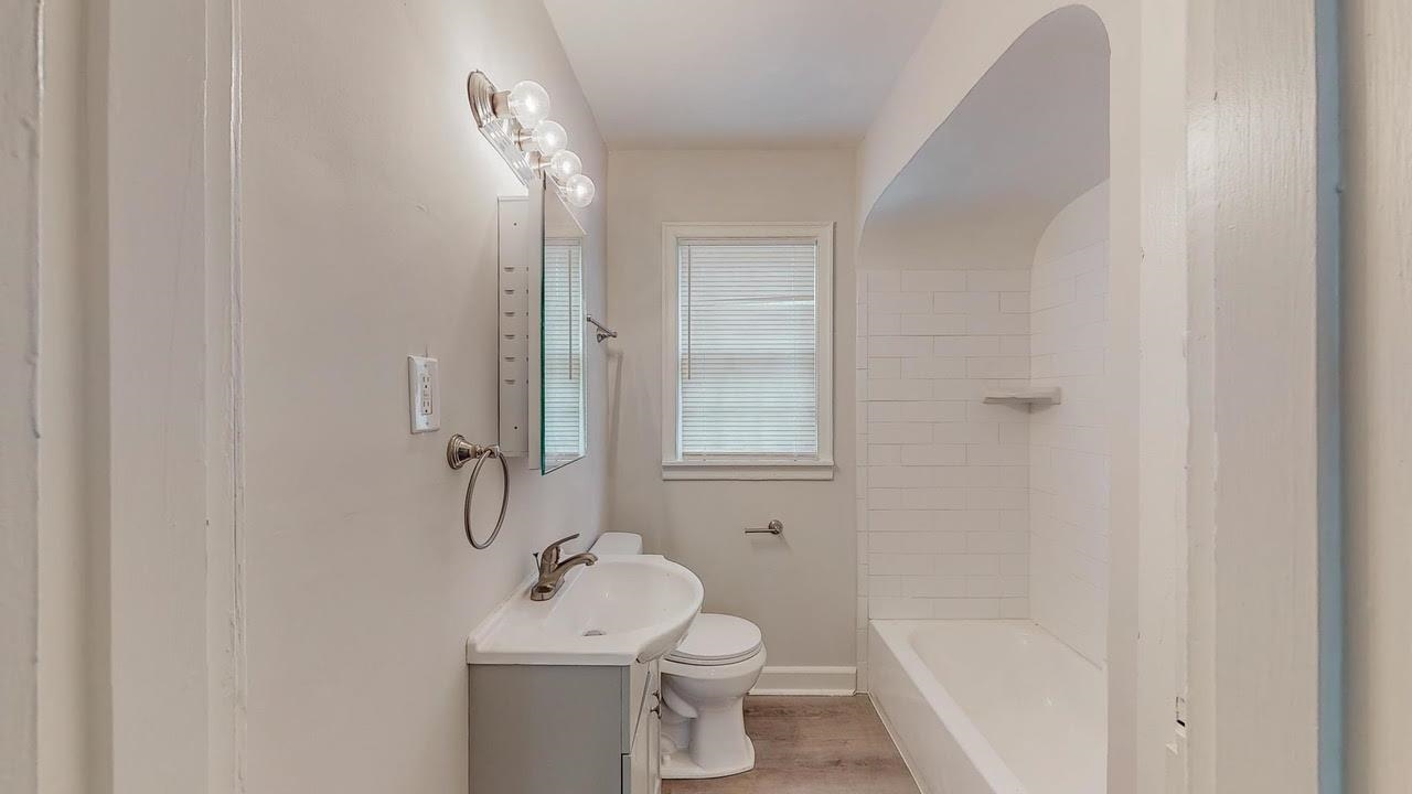 3393 Carrington Road Memphis, TN 38111 - Photo 5 of 11 Bathroom featuring vanity, shower combination, and light wood-style flooring