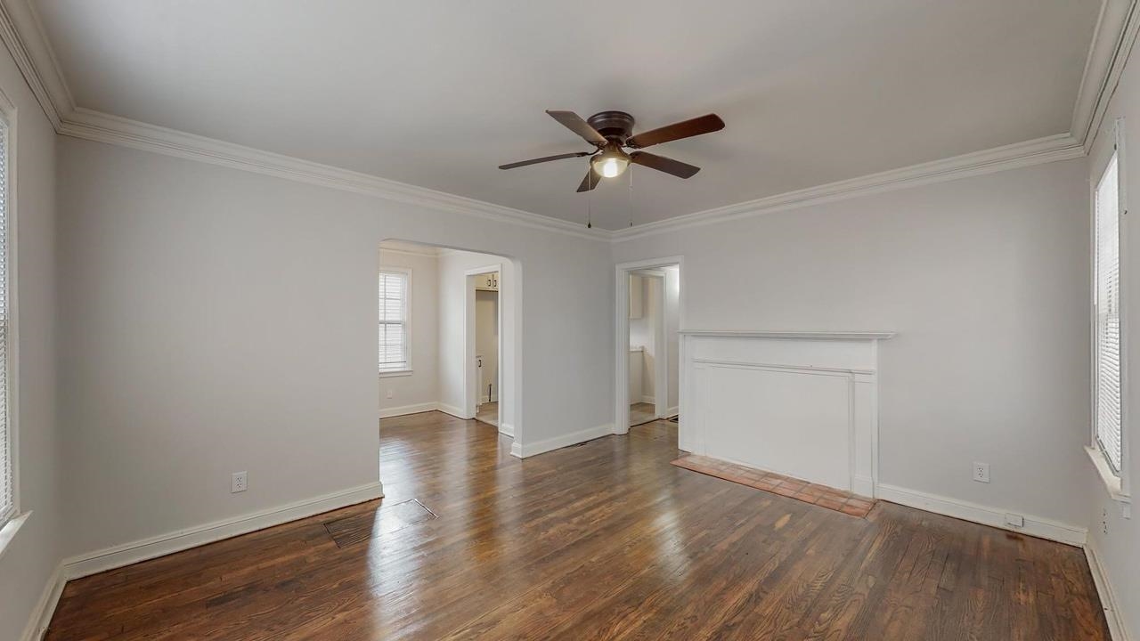 3393 Carrington Road Memphis, TN 38111 - Photo 7 of 11 Unfurnished living room with ornamental molding, dark wood-type flooring, and ceiling fan