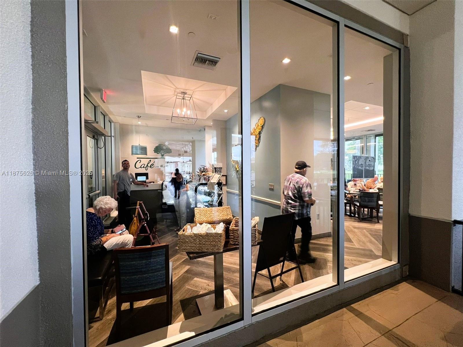 2002 Granada Drive, Unit J3 Coconut Creek, FL 33066 - Photo 20 of 24 a view of a hallway with dining room and furniture