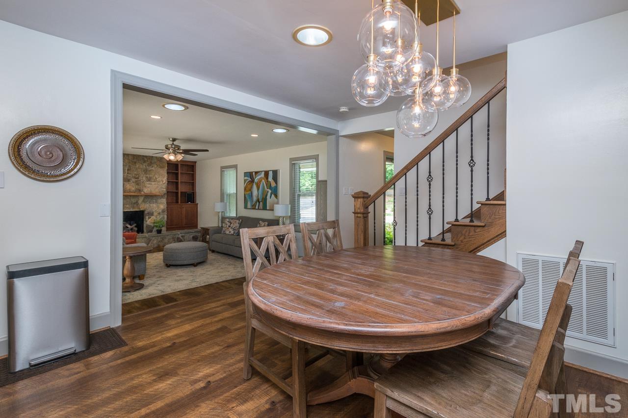 2505 Countrywood Road Raleigh, NC 27615 - Photo 11 of 36 a view of a dining room with furniture and wooden floor