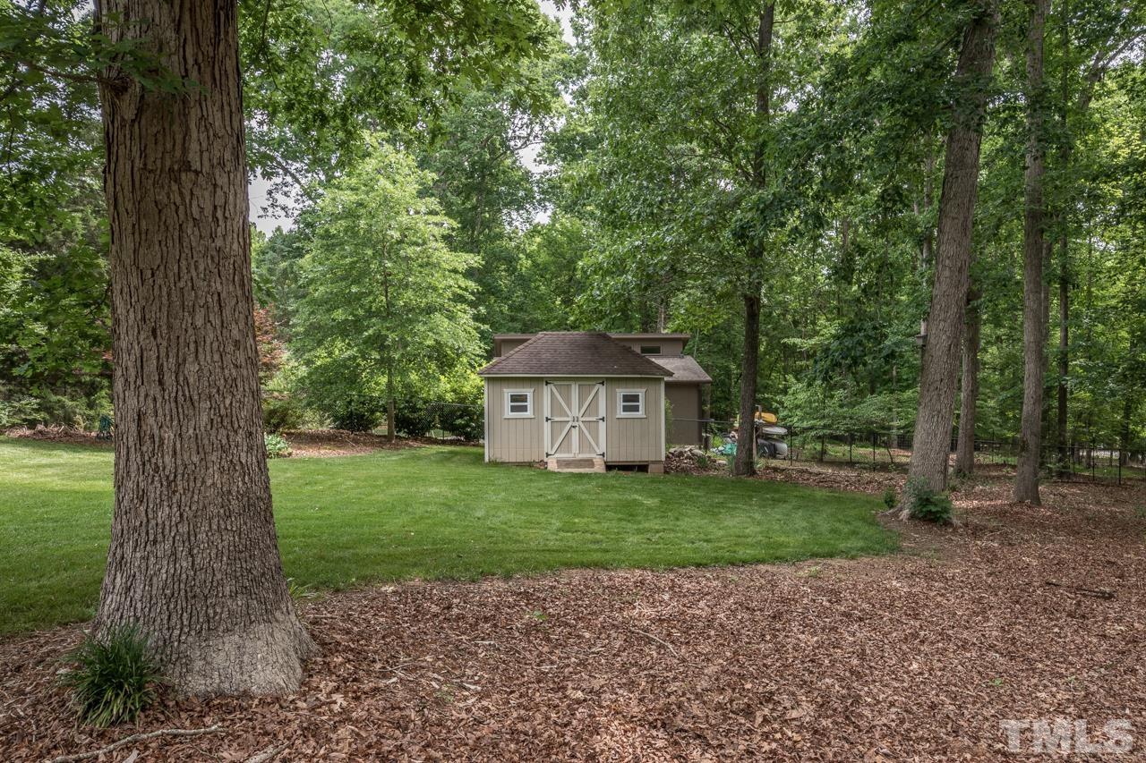 2505 Countrywood Road Raleigh, NC 27615 - Photo 17 of 36 a view of a house with a yard