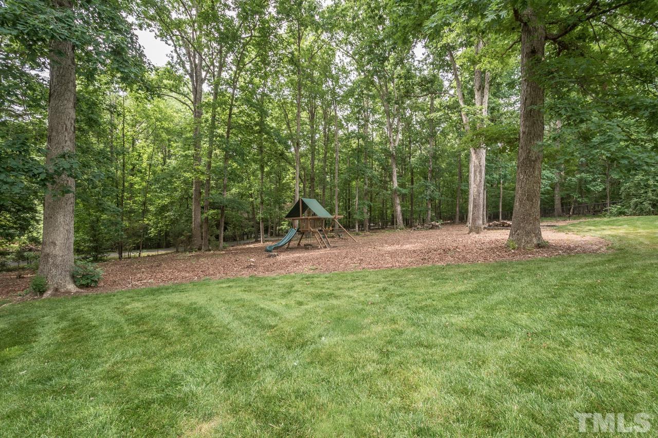 2505 Countrywood Road Raleigh, NC 27615 - Photo 19 of 36 a backyard of a house with lots of green space