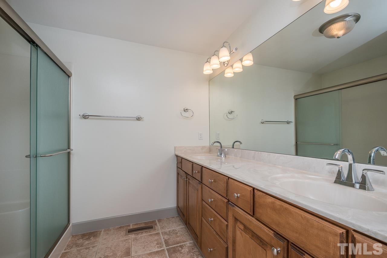 2505 Countrywood Road Raleigh, NC 27615 - Photo 24 of 36 a bathroom with a sink and a mirror