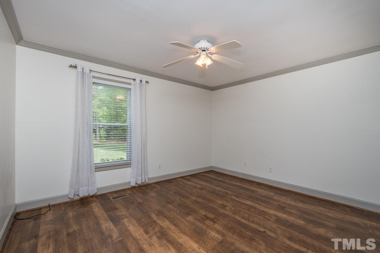 2505 Countrywood Road Raleigh, NC 27615 - Photo 27 of 36 wooden floor in an empty room with a window