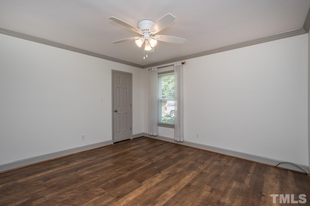 2505 Countrywood Road Raleigh, NC 27615 - Photo 28 of 36 an empty room with wooden floor and windows