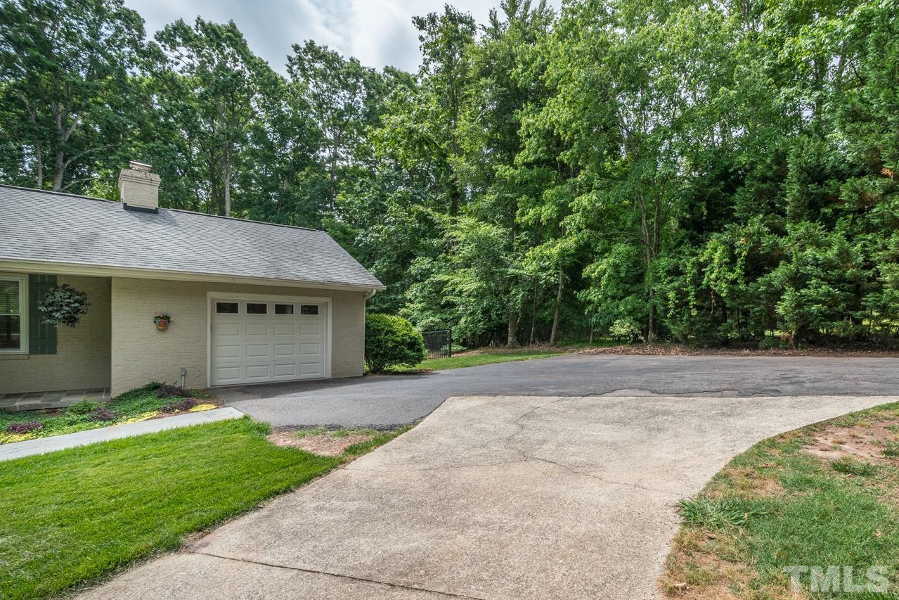 2505 Countrywood Road Raleigh, NC 27615 - Photo 35 of 36 a front view of a house with a garden