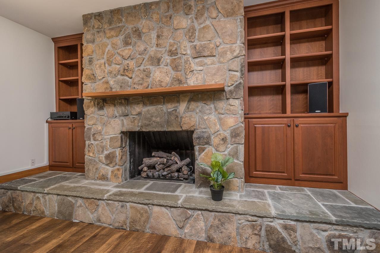 2505 Countrywood Road Raleigh, NC 27615 - Photo 4 of 36 a living room with furniture and a fireplace