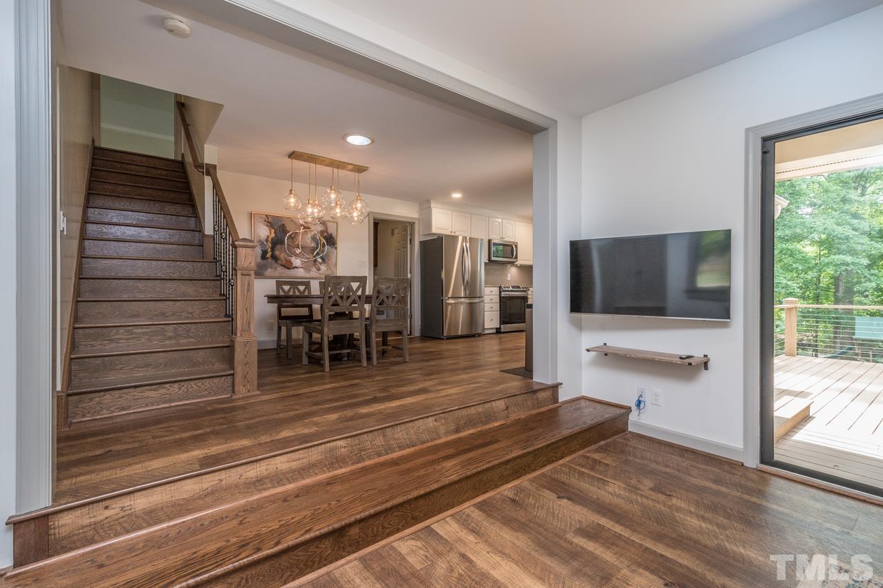 2505 Countrywood Road Raleigh, NC 27615 - Photo 6 of 36 a view of a living room and entry way to room with wooden floor