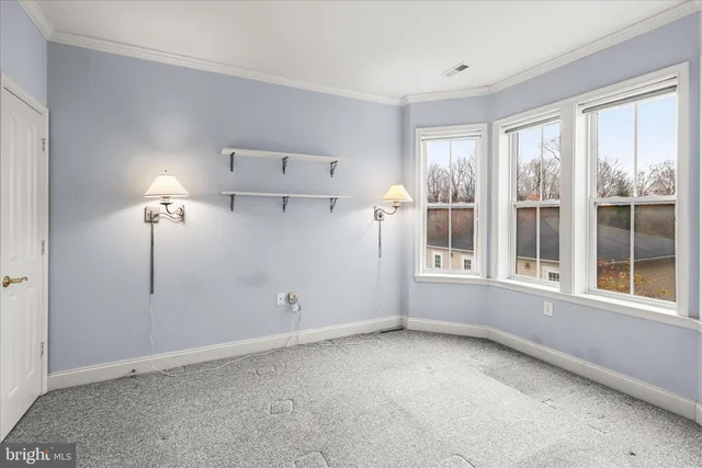 a view of a porch with furniture and wooden floor