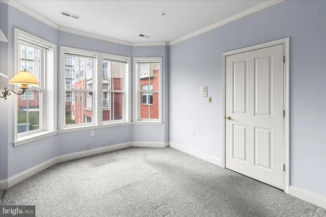 a living room with furniture large window and wooden floor
