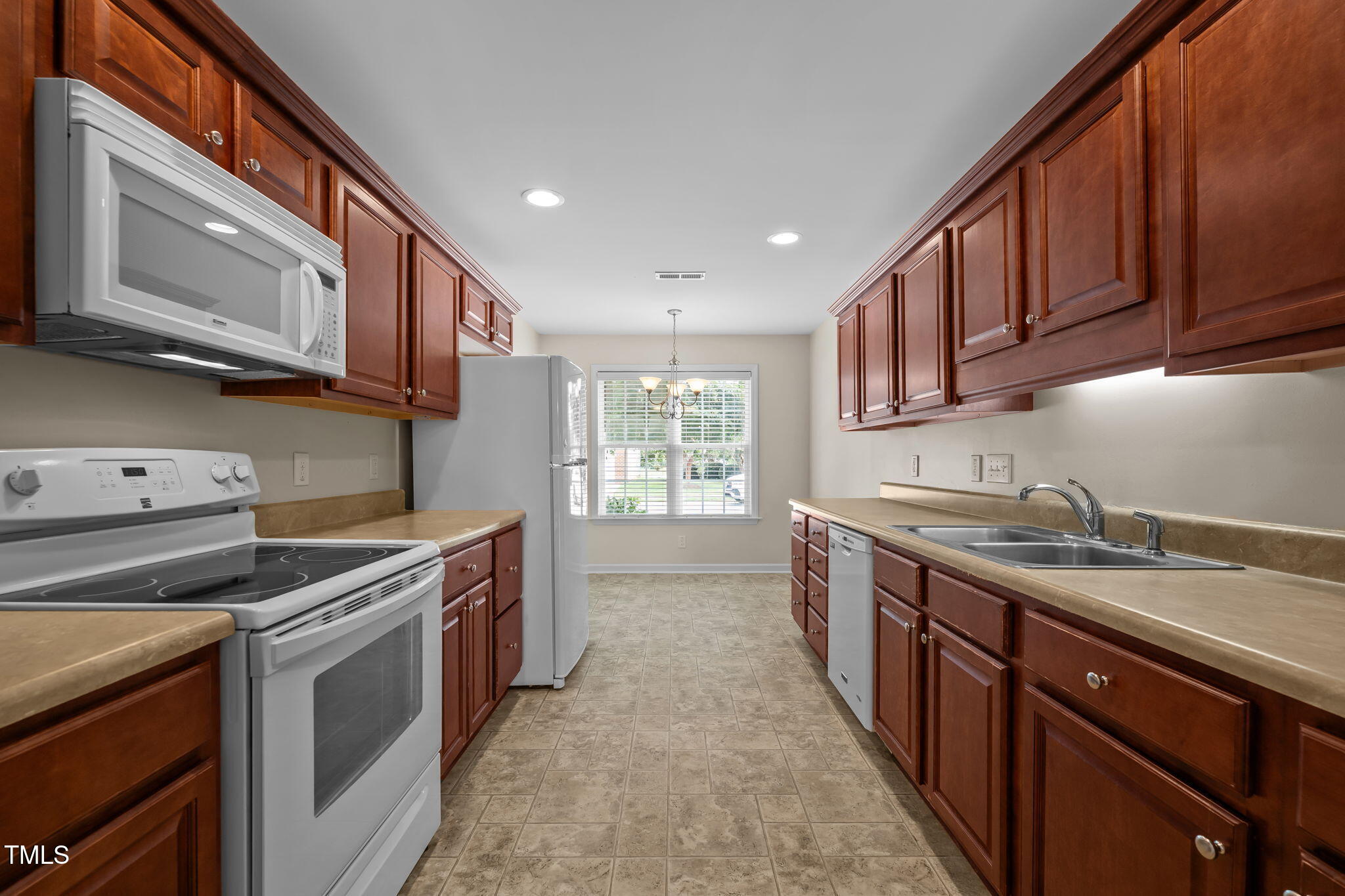 2002 Guinness Drive, Unit 5 Graham, NC 27253 - Photo 12 of 30 a kitchen with stainless steel appliances granite countertop a stove a sink and a microwave