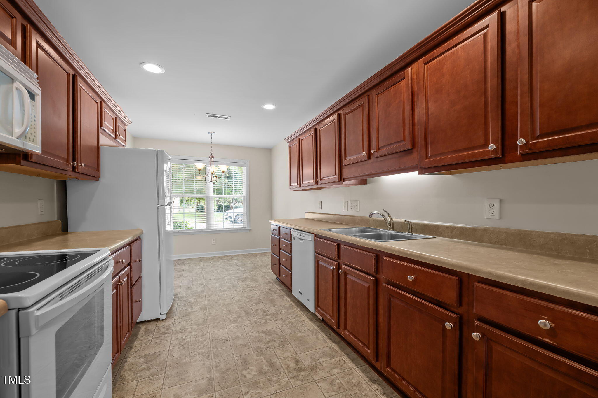2002 Guinness Drive, Unit 5 Graham, NC 27253 - Photo 13 of 30 a kitchen that has a sink and a stove