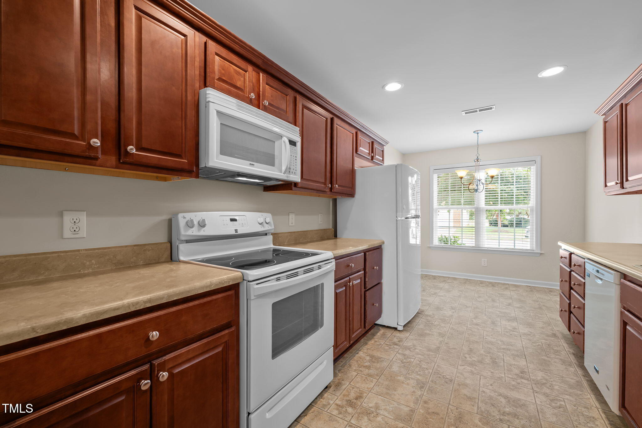 2002 Guinness Drive, Unit 5 Graham, NC 27253 - Photo 14 of 30 a kitchen with stainless steel appliances granite countertop a stove a sink and a microwave