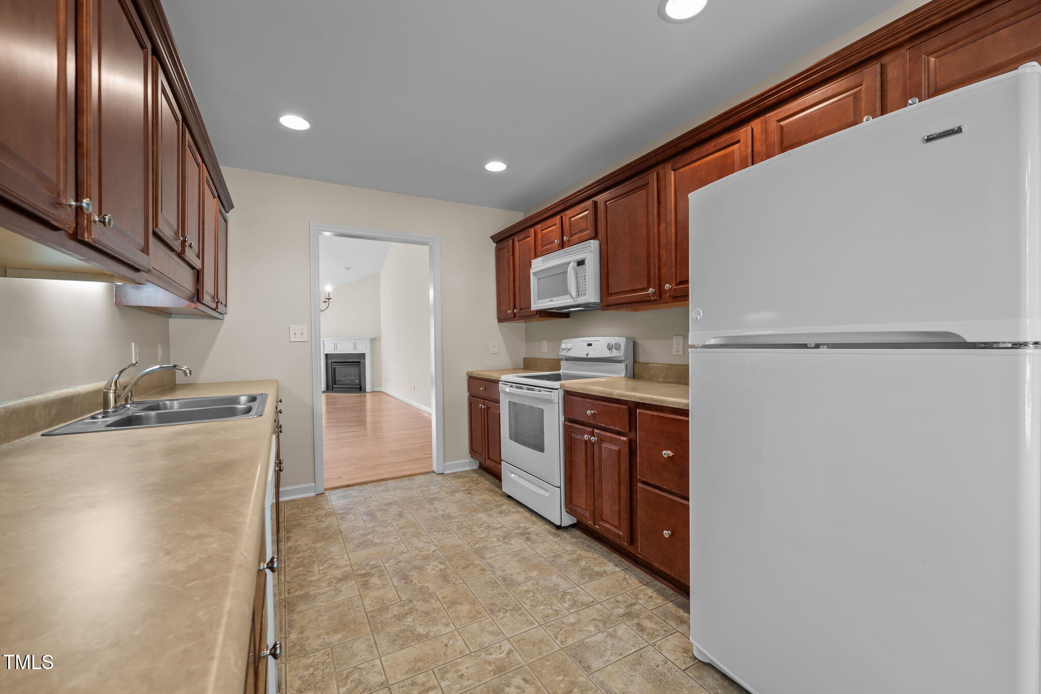 2002 Guinness Drive, Unit 5 Graham, NC 27253 - Photo 15 of 30 a kitchen with stainless steel appliances granite countertop a refrigerator a stove and a sink