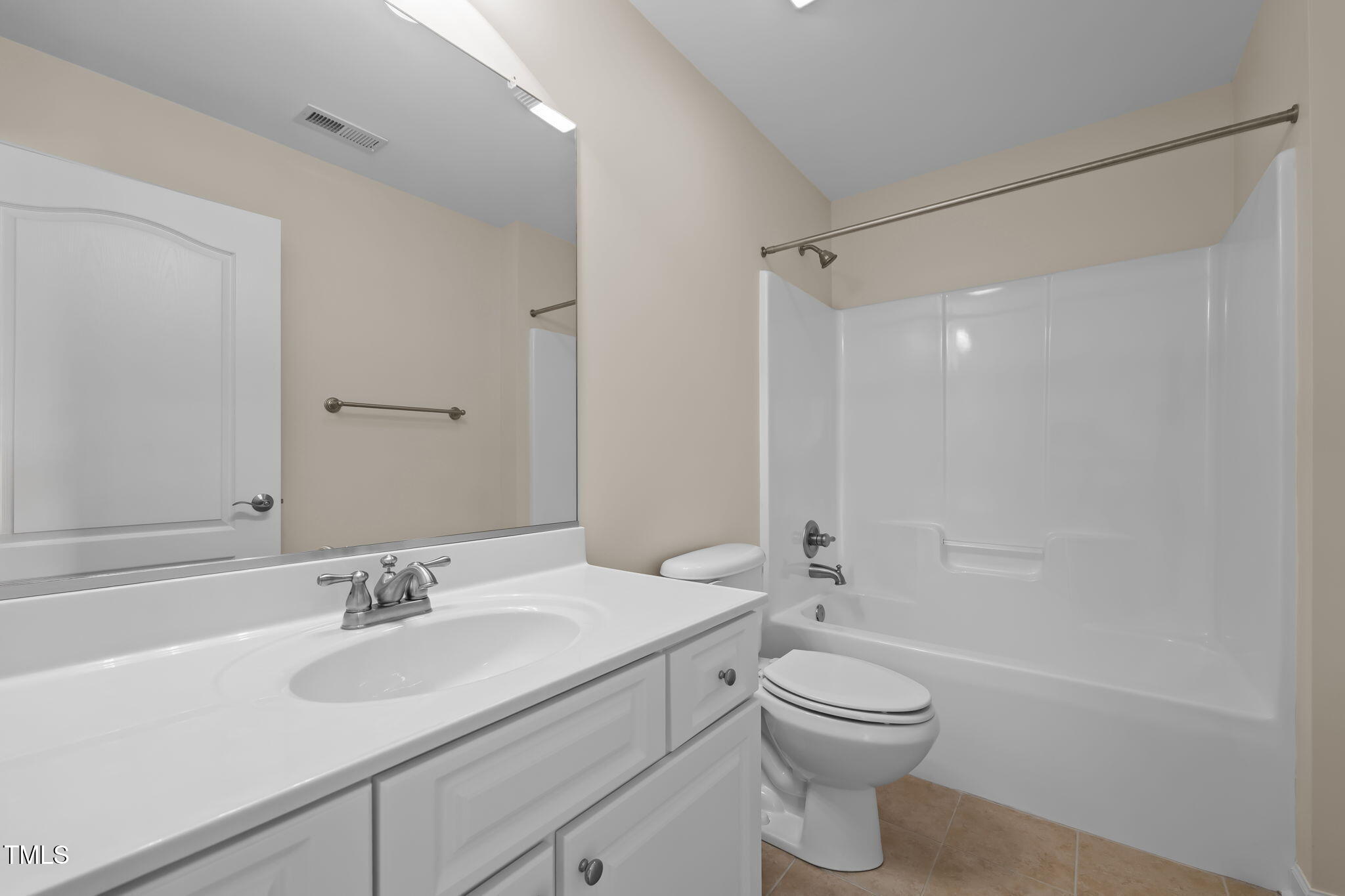 2002 Guinness Drive, Unit 5 Graham, NC 27253 - Photo 19 of 30 a bathroom with a toilet a sink a mirror and a shower