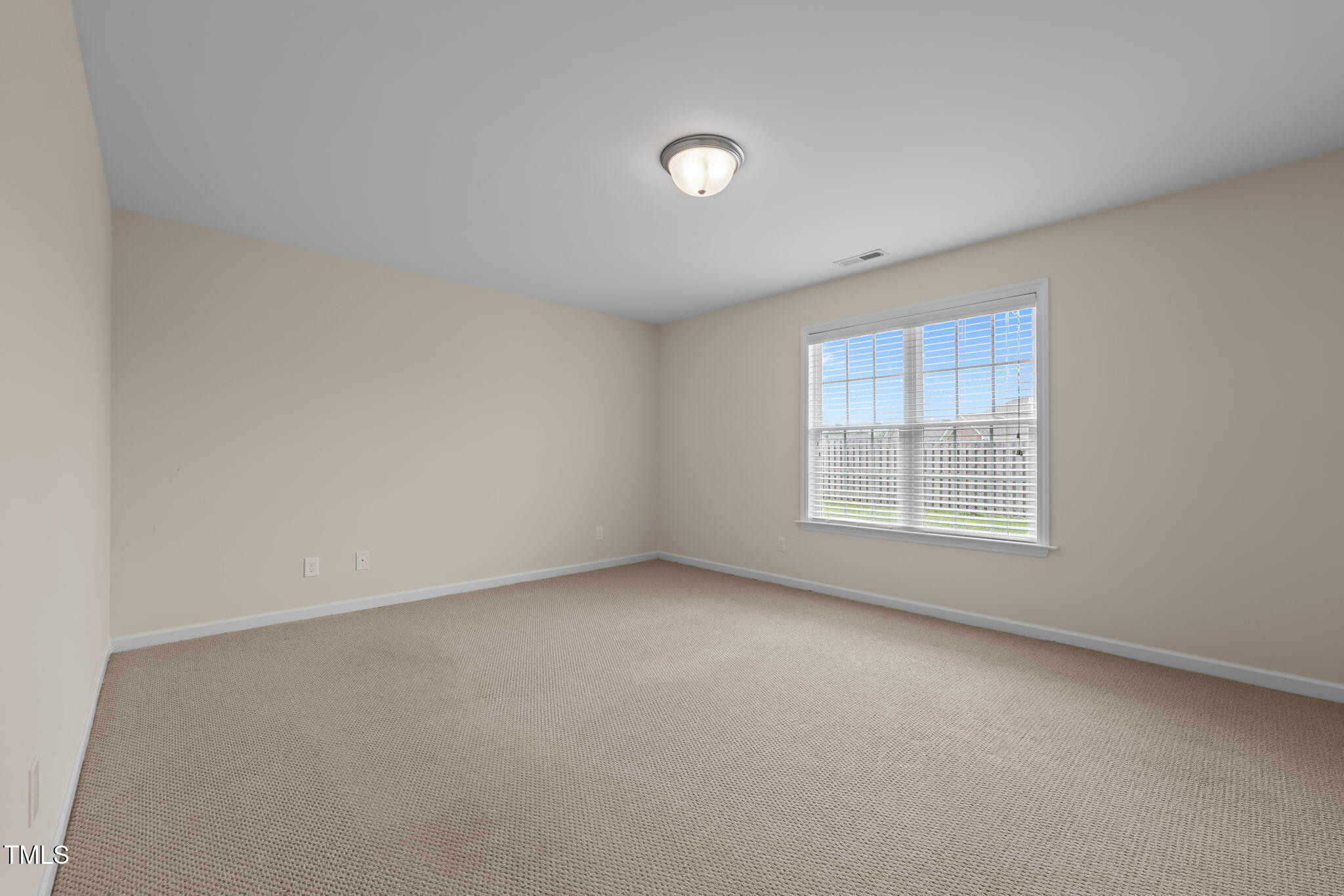 2002 Guinness Drive, Unit 5 Graham, NC 27253 - Photo 23 of 30 an empty room with a window