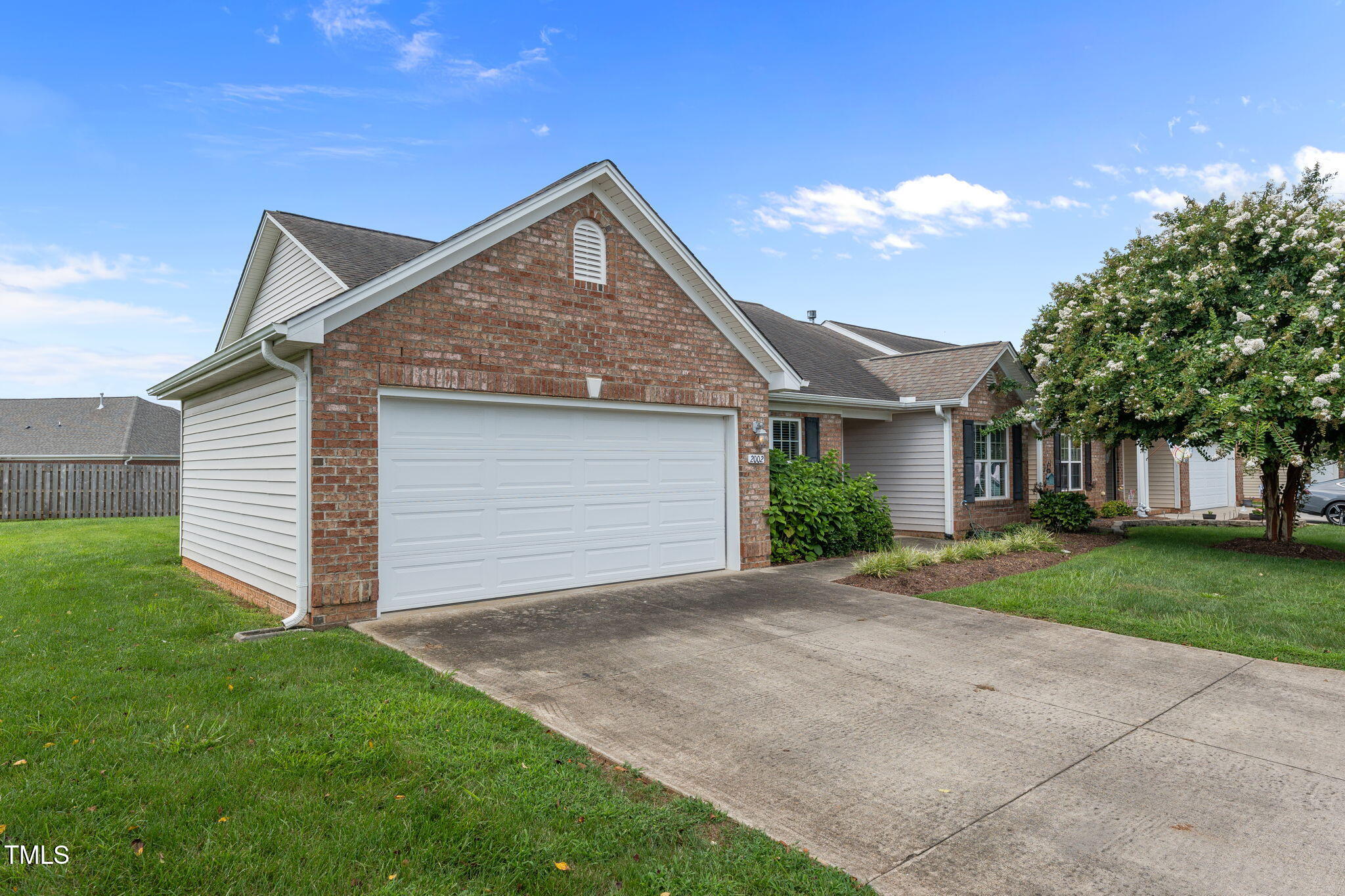 2002 Guinness Drive, Unit 5 Graham, NC 27253 - Photo 30 of 30 a front view of a house with a yard and garage