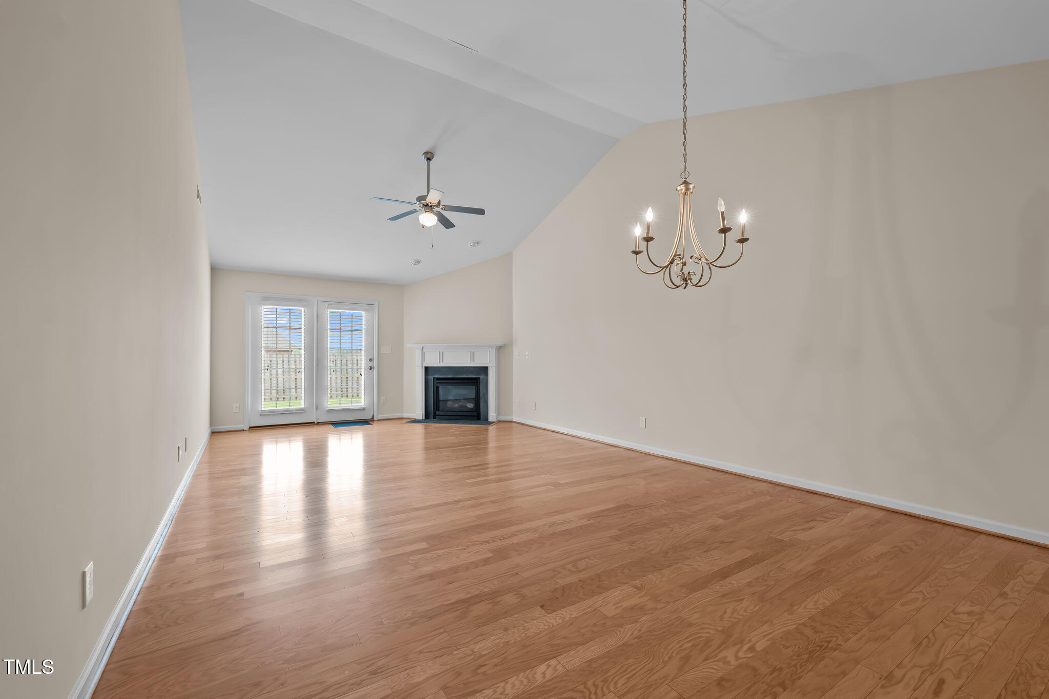 2002 Guinness Drive, Unit 5 Graham, NC 27253 - Photo 3 of 30 a view of an empty room with chandelier and wooden floor