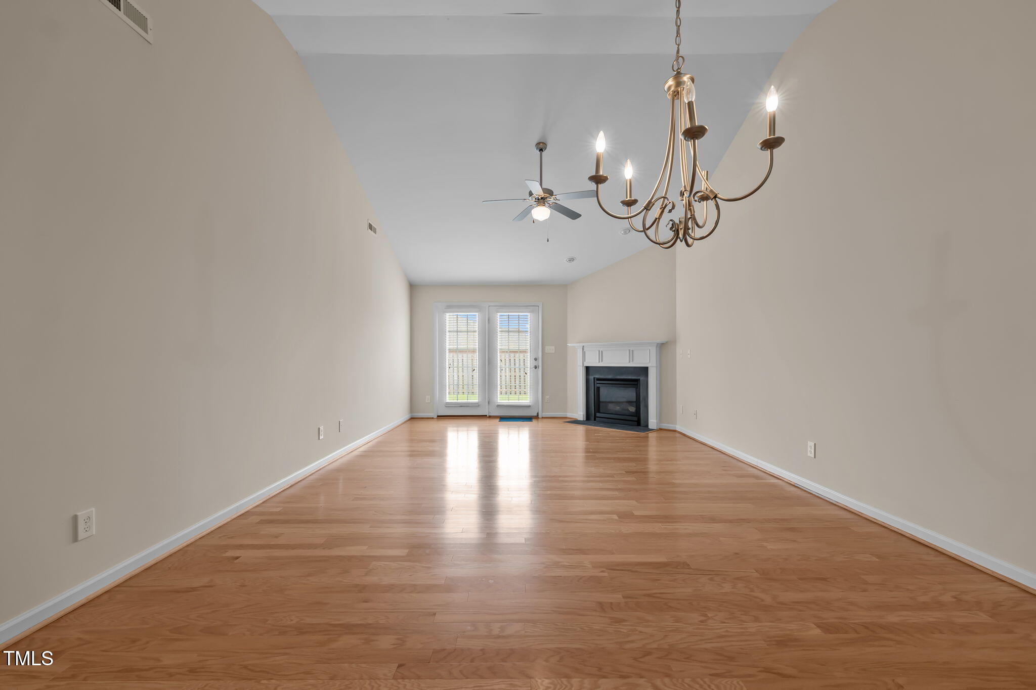 2002 Guinness Drive, Unit 5 Graham, NC 27253 - Photo 4 of 30 a view of an empty room with a chandelier fan and fireplace