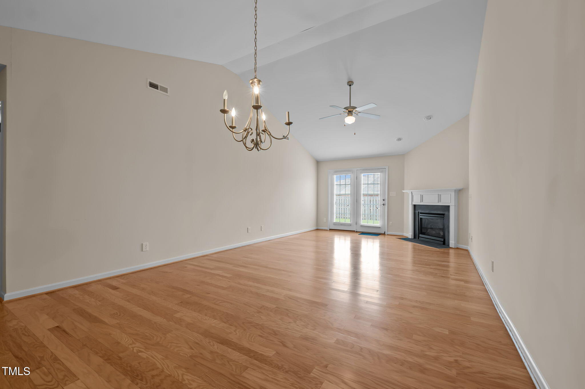 2002 Guinness Drive, Unit 5 Graham, NC 27253 - Photo 5 of 30 a view of an empty room with wooden floor and a window