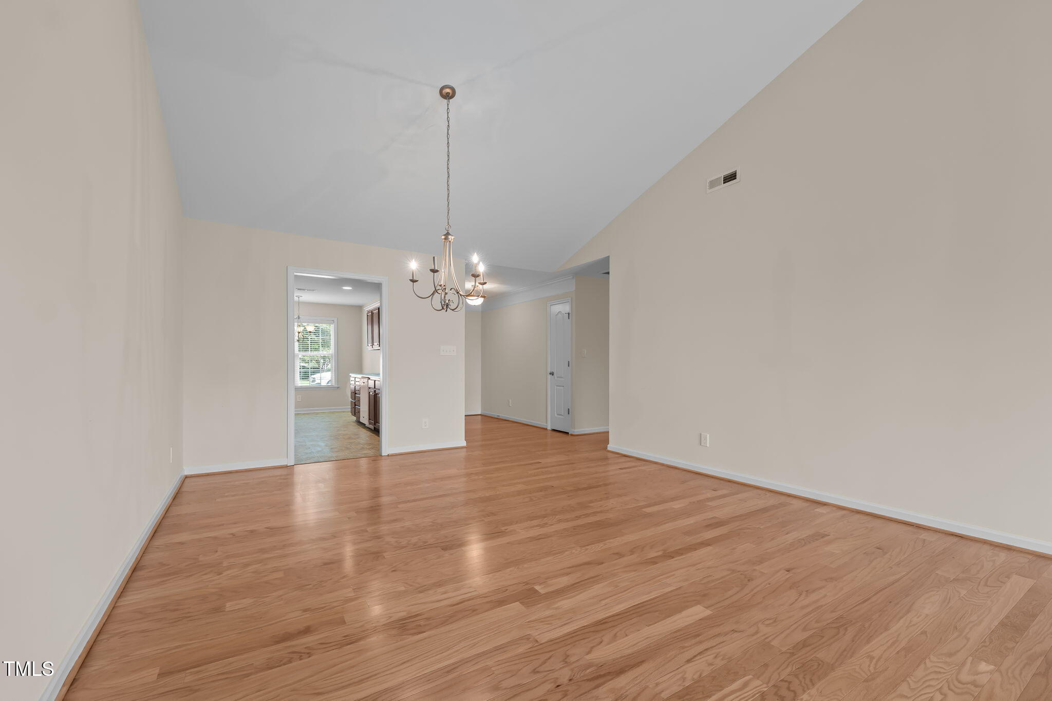 2002 Guinness Drive, Unit 5 Graham, NC 27253 - Photo 8 of 30 a view of a room with a chandelier fan and wooden floor