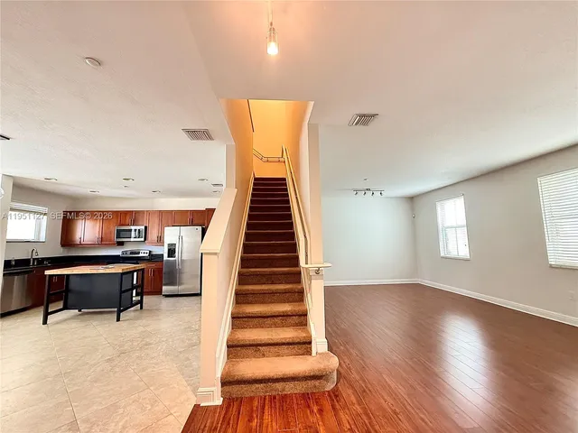 a view of a livingroom with furniture and staircase