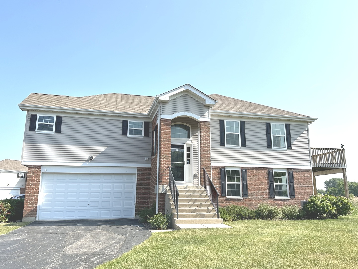 a front view of a house with a garden and yard